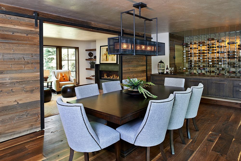 Sliding barn doors bring reclaimed wood to this rustic dining room [Design: Gregg & Co Builders]