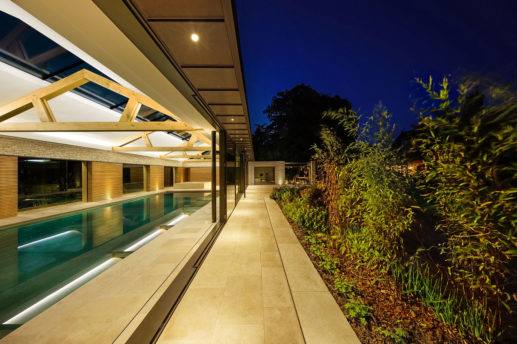 Sliding-glass-doors-connect-the-pool-house-with-the-landscape-and-the-house