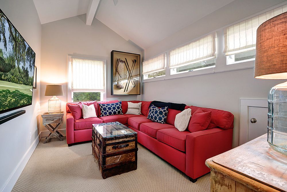 Small beach style media room with bright red couch and coastal themed décor [From: Distinctive Design / Build / Remodel - William Quarles Photography]