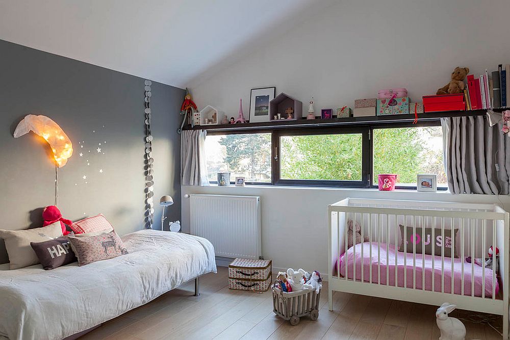 Small industrial nursery design idea in white with gray feature wall [Design: Marque de Fabrik]