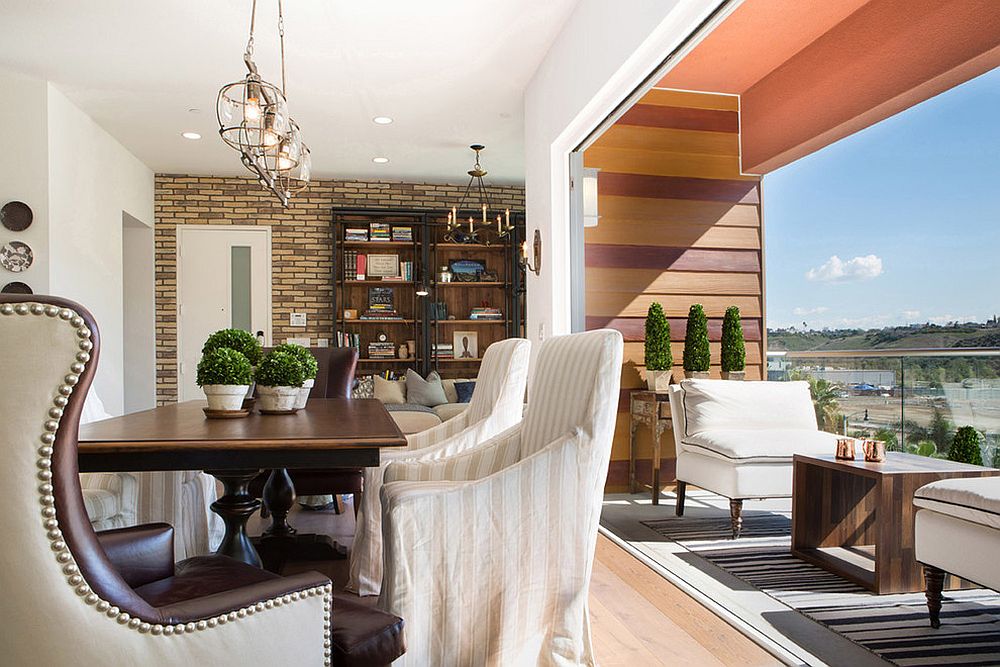 Small industrial sunroom with dining connected with the open balcony that offers wonderful views [Design: Lori Dennis]