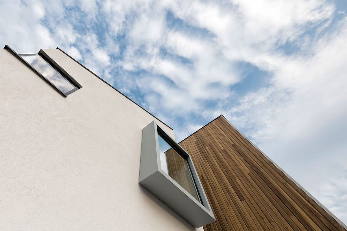 Smart design of protruding bay windows makes the house distinct