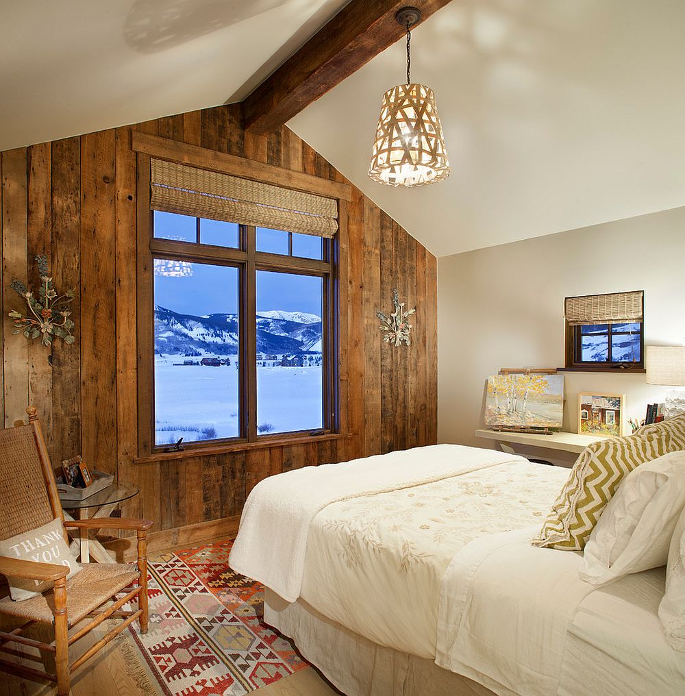 Spacious and serene rustic bedroom with reclaimed wood accent wall that frames the view outside [Design: Sunlit Architecture]