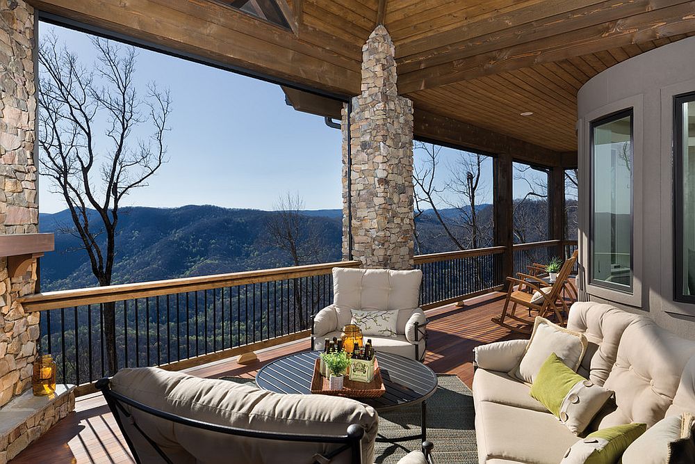 Stone pillars and fireplace give the beautiful deck a rustic touch