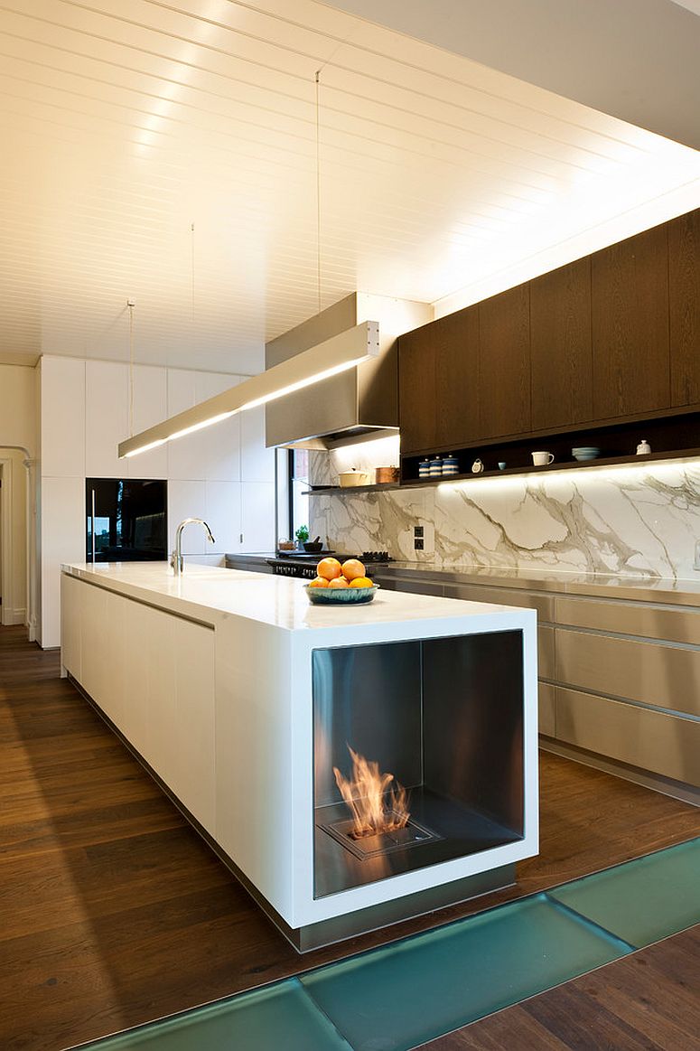 Stylish contemporary kitchen with fireplace built into the island [Design: EcoModern Design]