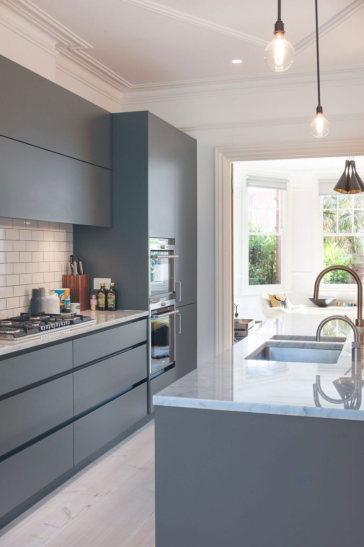 Stylish modern kitchen in shades of bluish-gray and white is an absolute showstopper