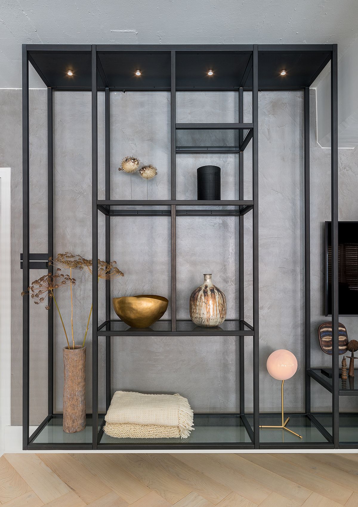 Tall industrial shelves were crafted to fit in with the scale and style of the contemporary loft