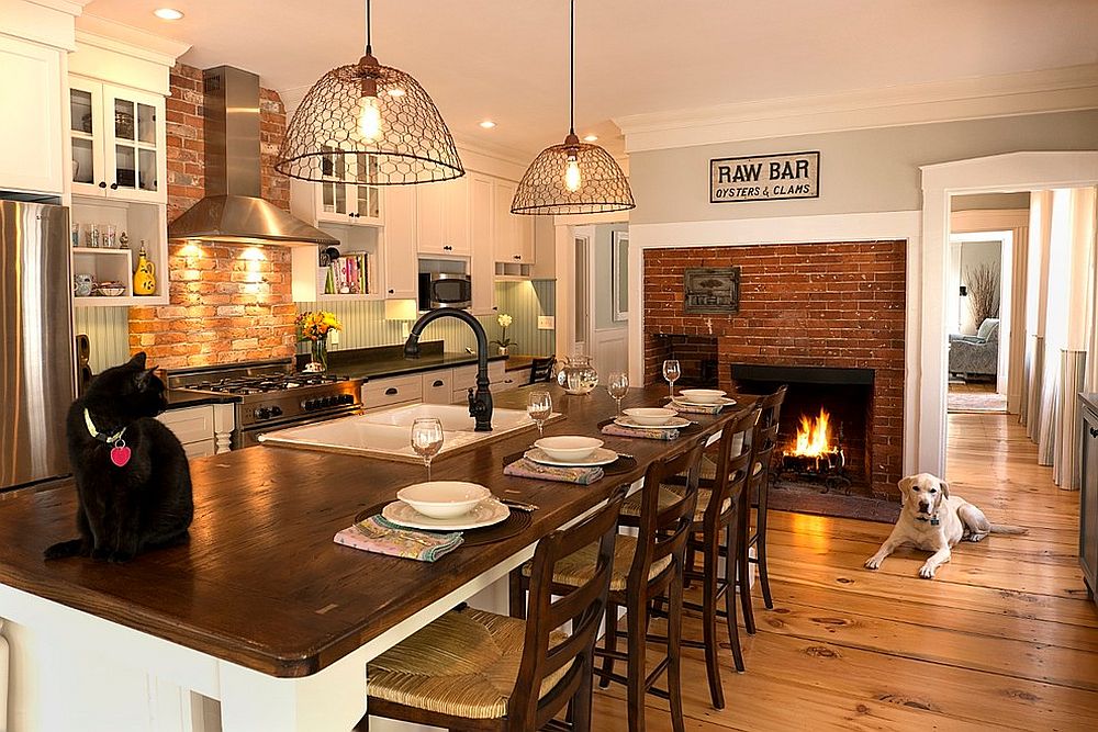 Traditional brick fireplace serves both the kitchen and the breakfast zone [Design: Open Meadow]