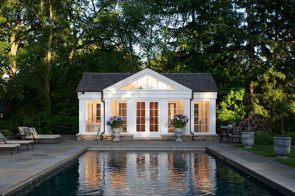 Traditional pool house in white with gray shingled roof