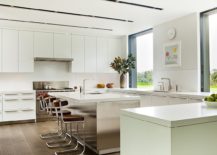 White-kitchen-design-with-a-spacious-central-island-and-breakfast-bar-217x155