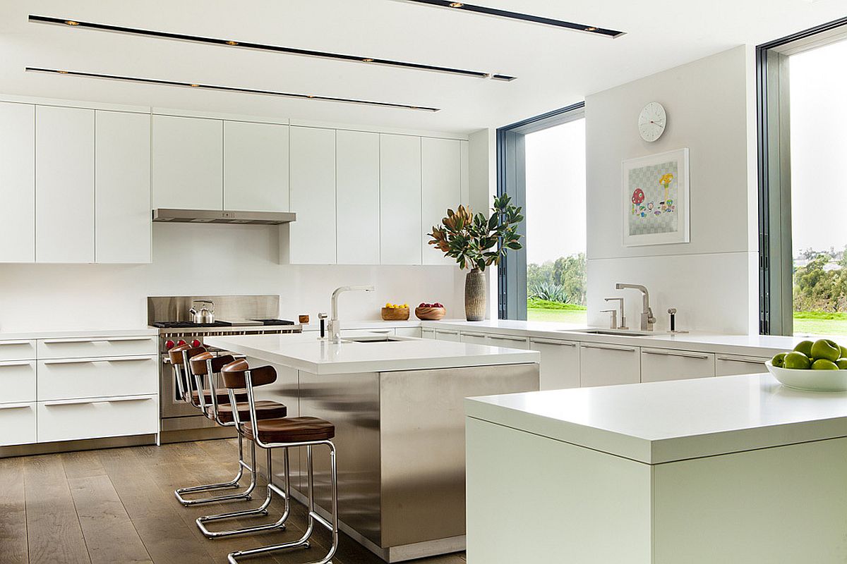 White kitchen design with a spacious central island and breakfast bar