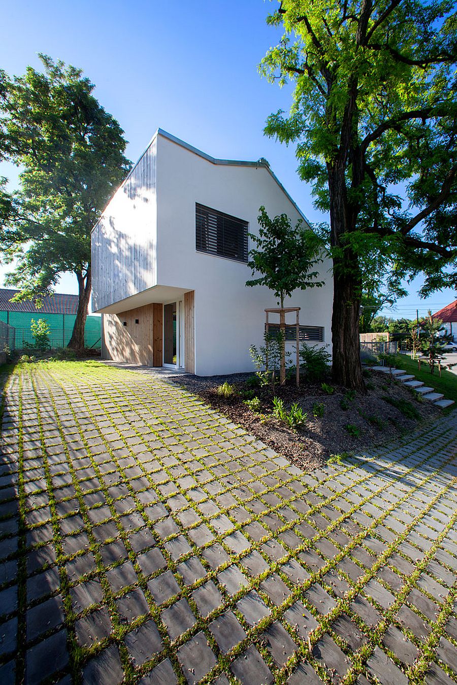 White plaster, wood and glass home on a raised lot in Slovakia