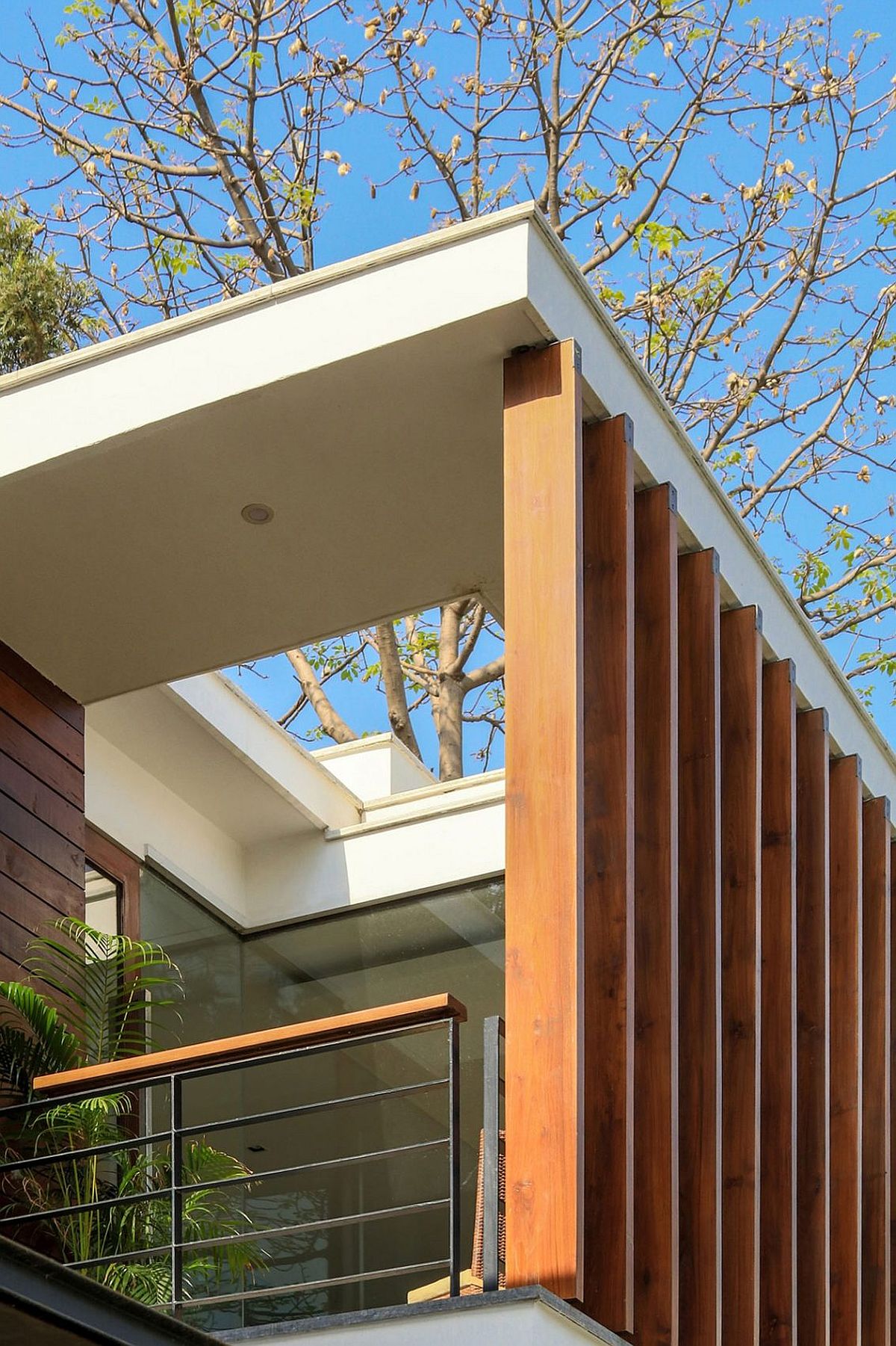 Wooden slats offer shade and privacy to the balcony