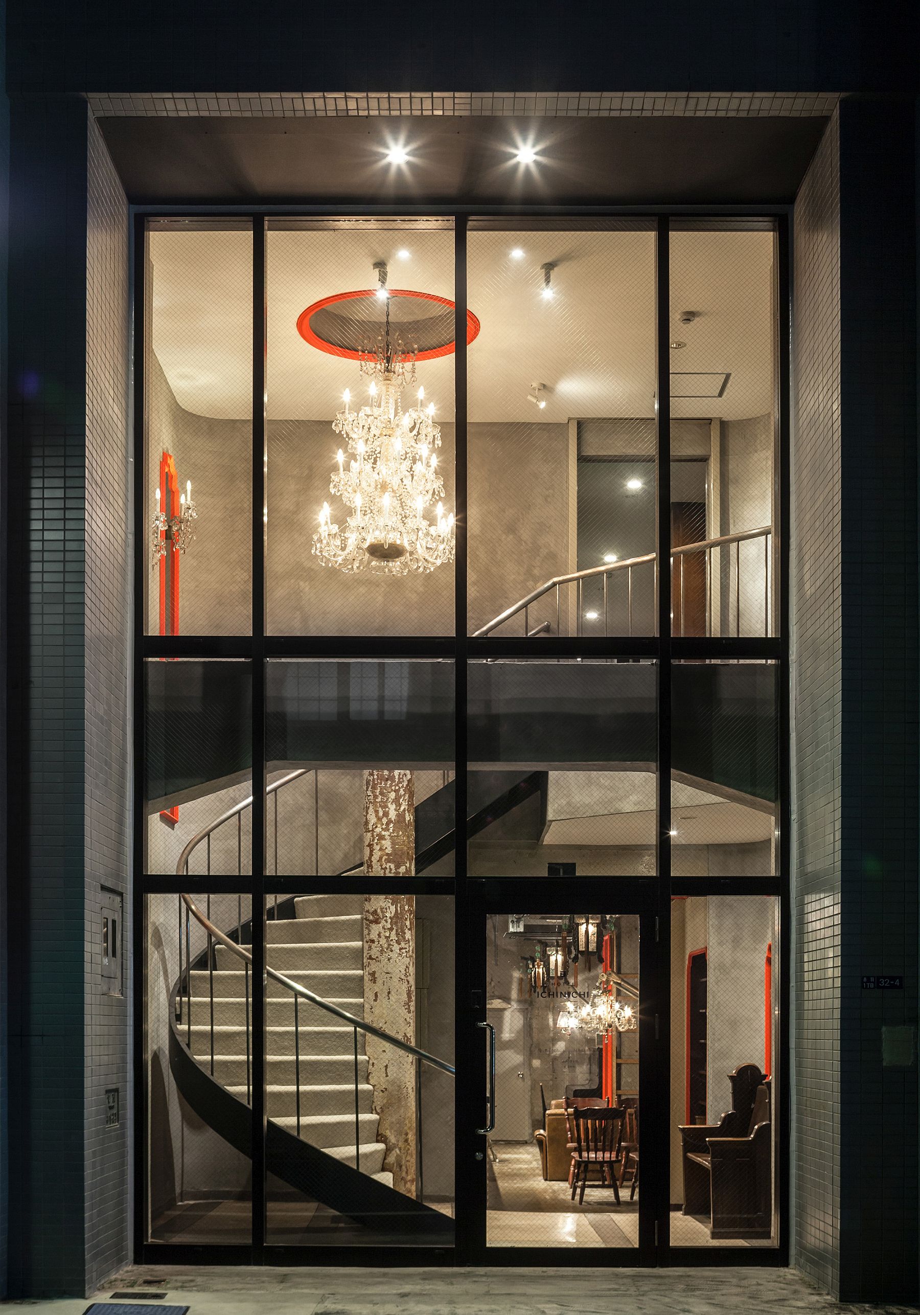 A stunning view of the entry with spiral staircase and grand chandelier