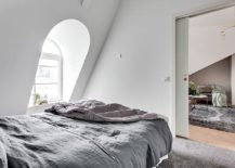 Bedroom-of-the-small-attic-apartment-in-white-and-gray-217x155