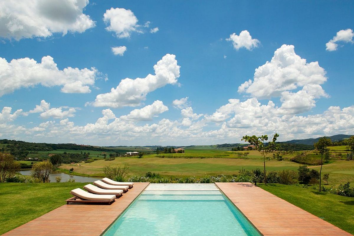 Brazilian teak deck flanks the gorgeous infinity edge pool of the Sao Paulo home