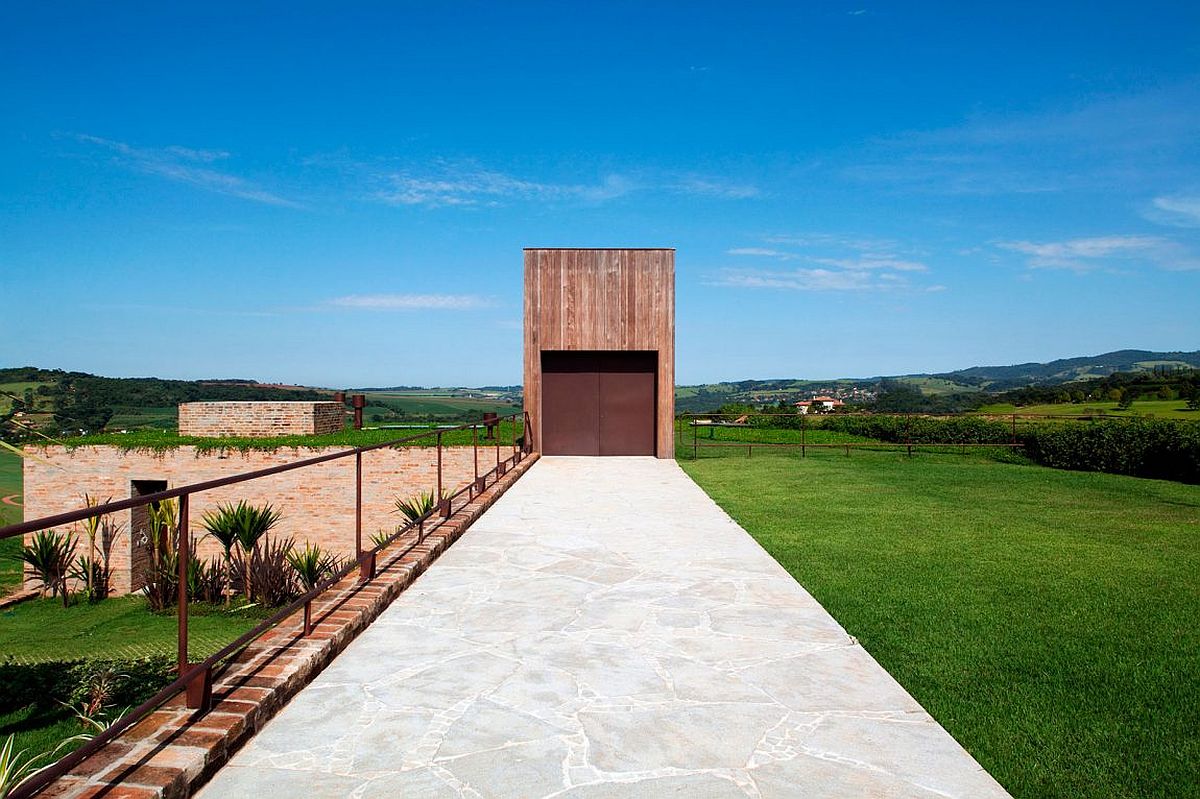 Brazilian teak structure and corten steel door create a unique and striking entrance for the house