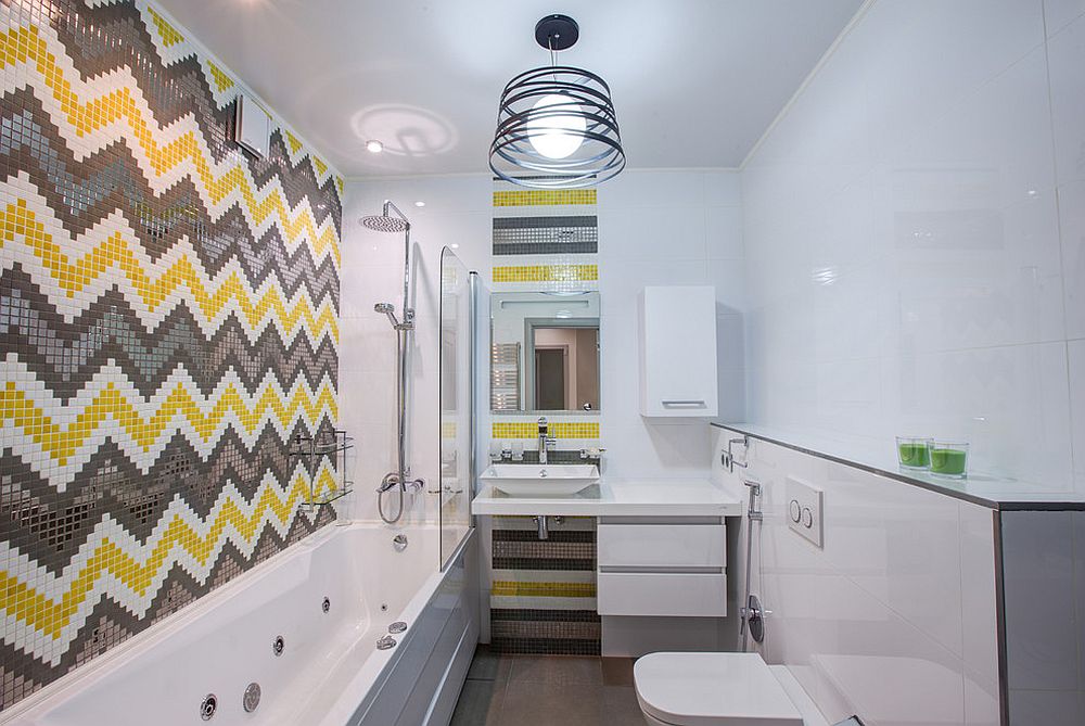 Chevron patterned tile design in yellow and gray create a striking bathroom