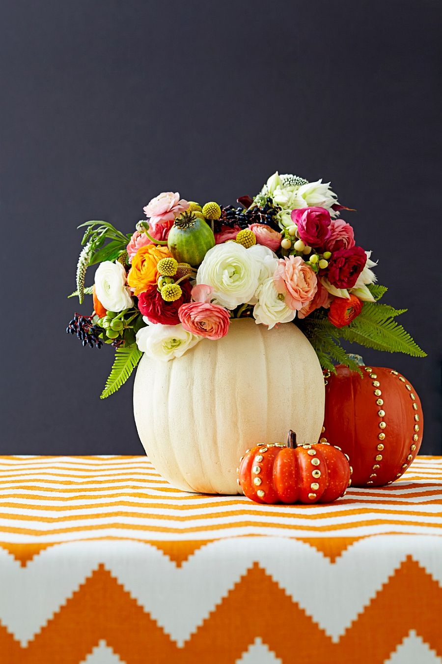 Colorful blend of flowers and pumpkins creates a stunning centerpiece