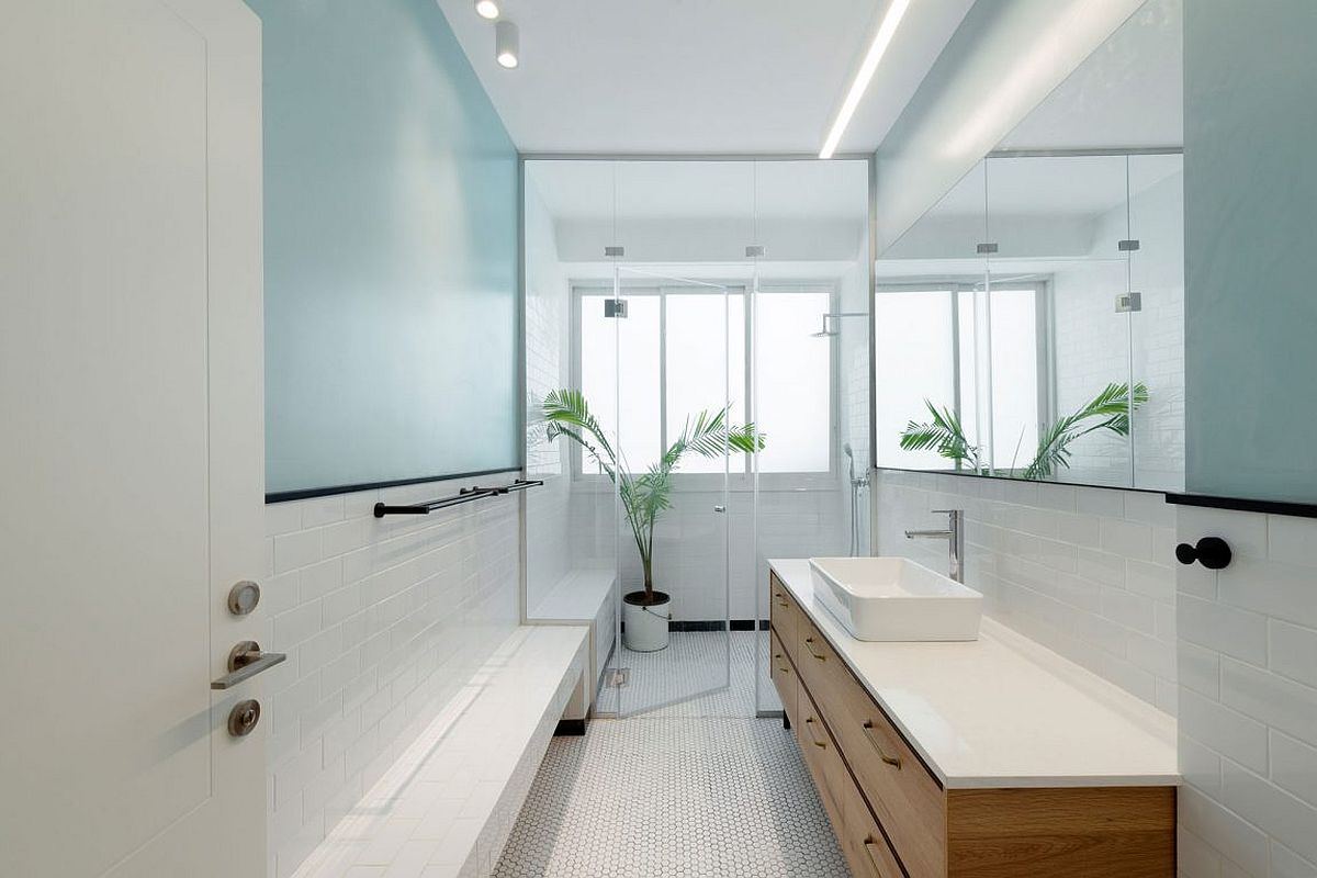 Contemporary bathroom in white and light blue with ample natural lighting