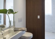 Contemporary-bathroom-in-white-with-sliding-wooden-doors-217x155