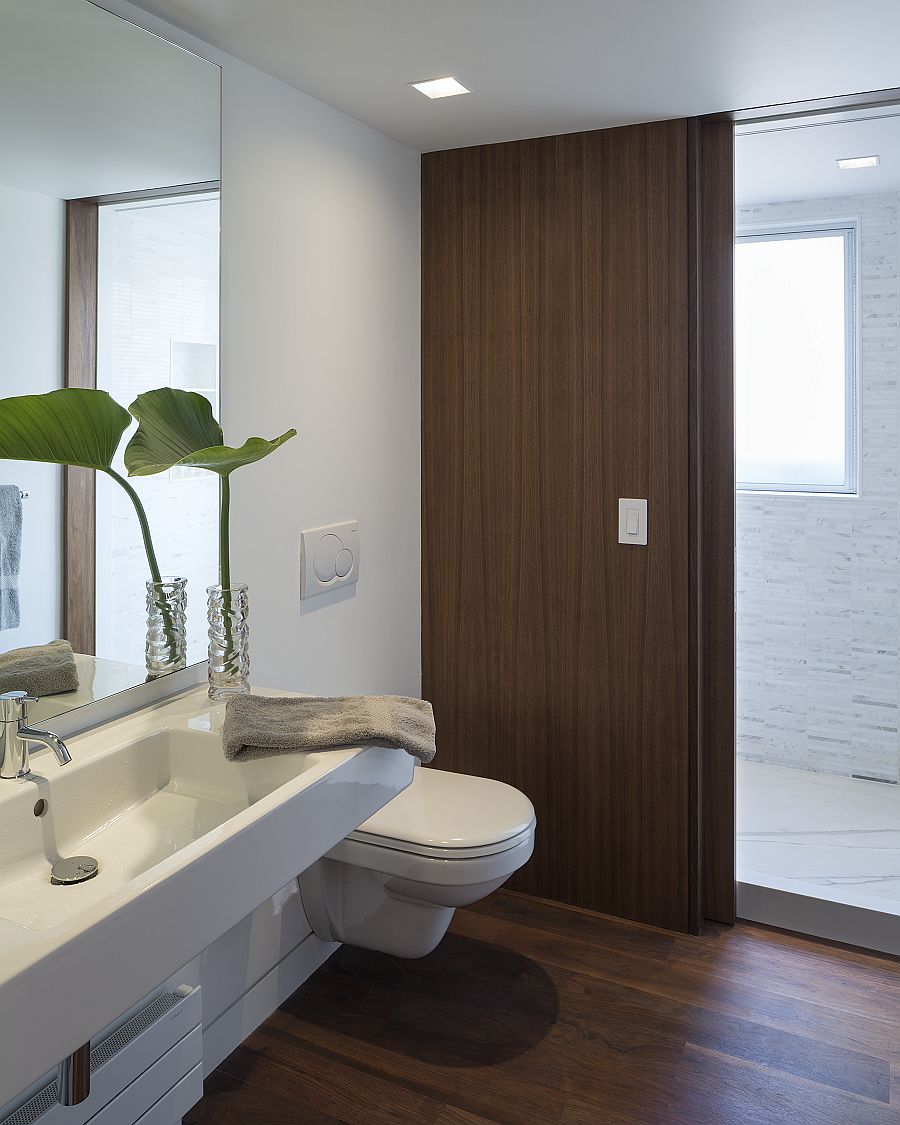 Contemporary bathroom in white with sliding wooden doors