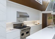 Contemporary-kitchen-with-sixteen-foot-long-Corian-kitchen-island-217x155