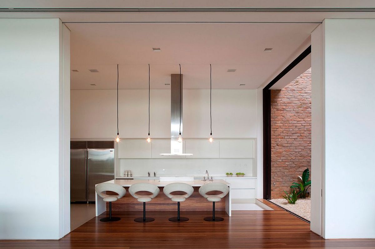 Contemporray kitchen in white with Edison bulbs above the island