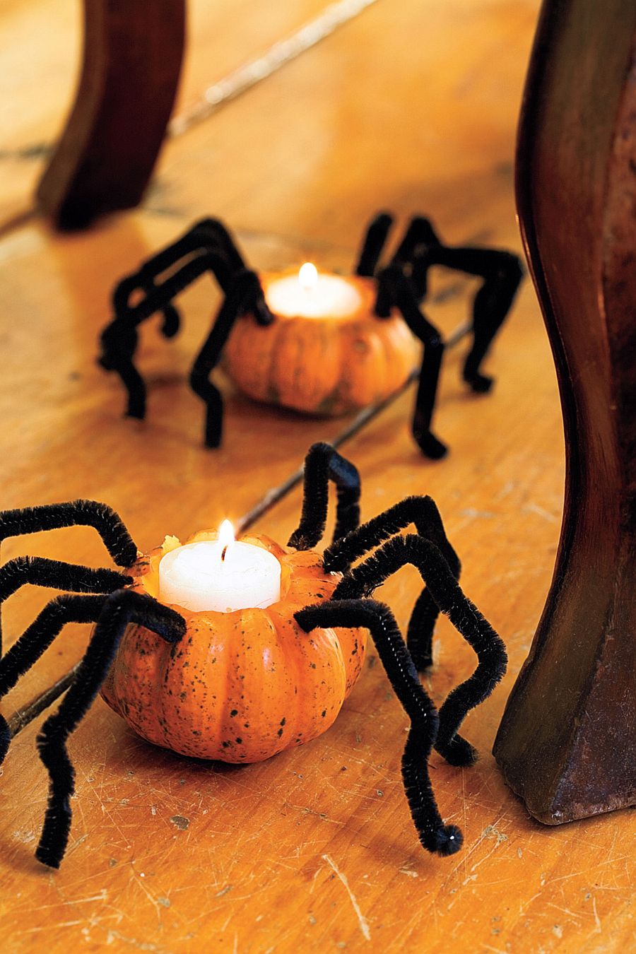 Creepy spider pumpkins with candles combine spooky design with lovely lighting