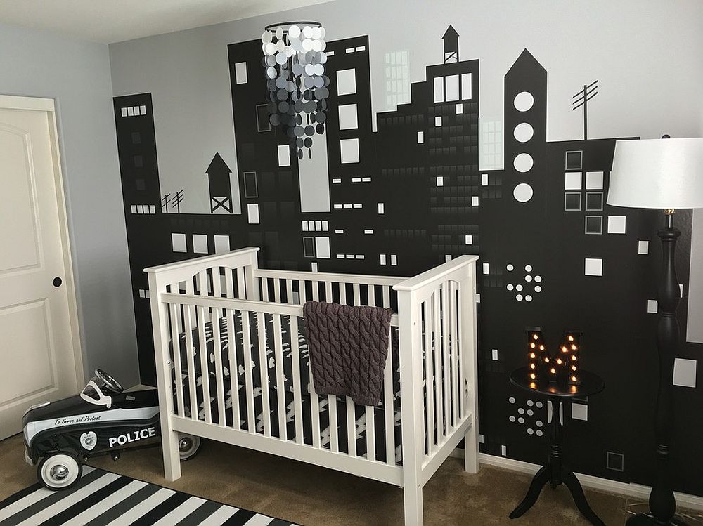 Custom wall mural in the nursery depicts a bright city skyline