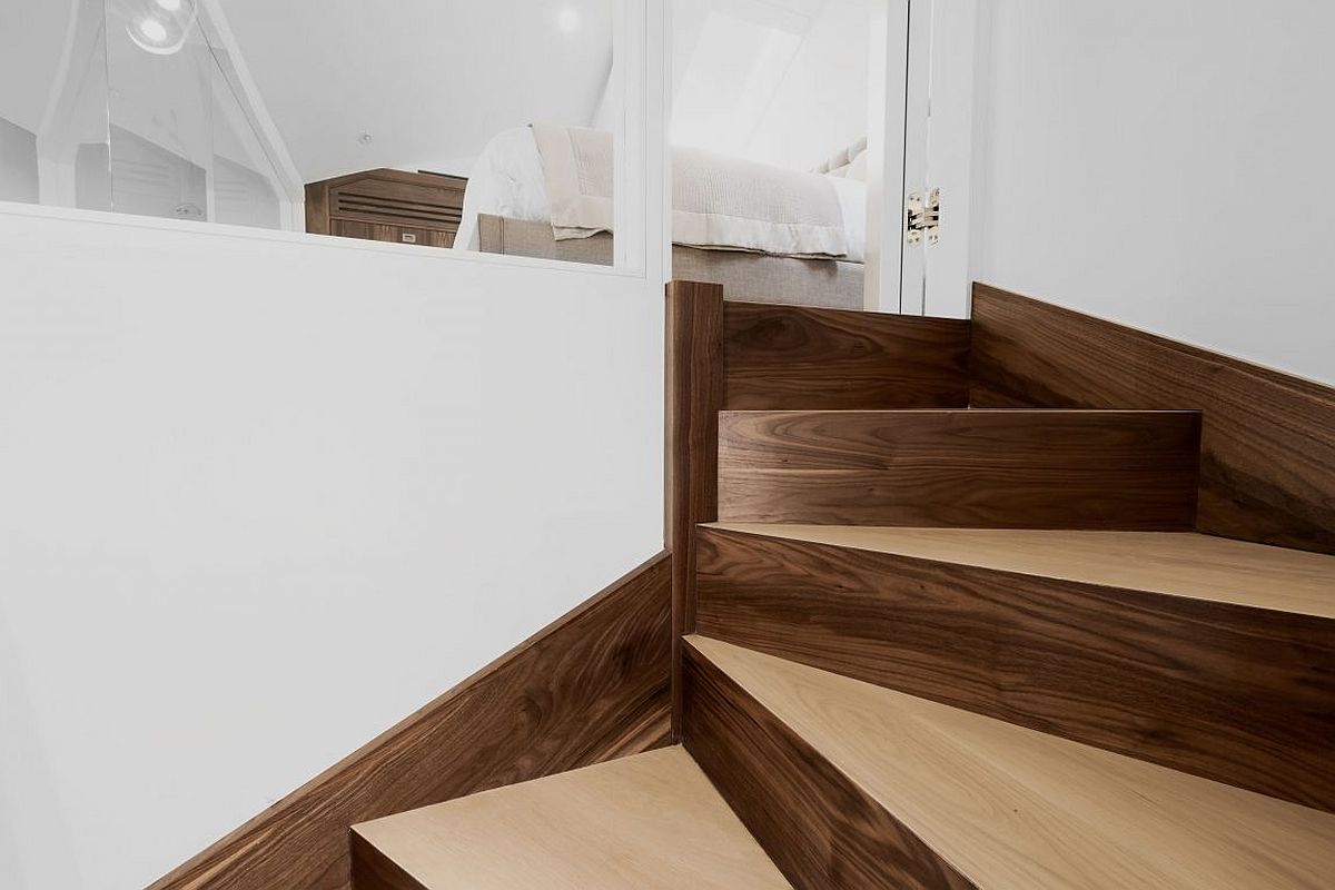 Custom walnut oak staircase connecting the living area with mezznine level master bedroom