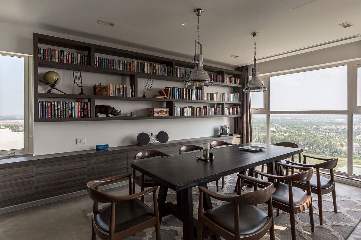 Dark gray cabinets and dining table for the dining room that also serves as home library