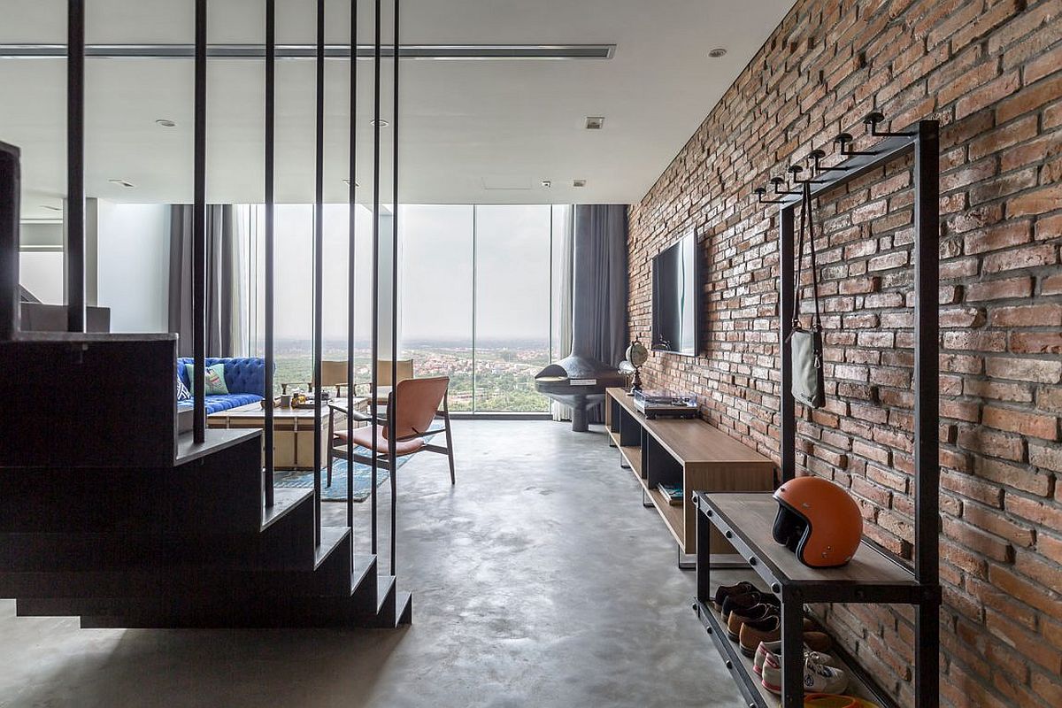 Exposed brick wall gives the living room an industrial appeal