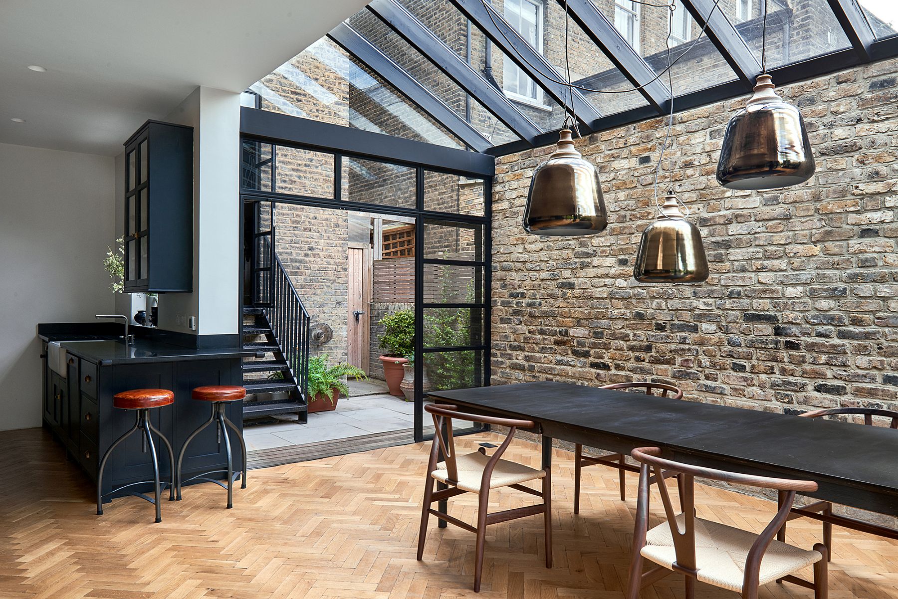 Framed glass doors and a steel structure give the Victorian London home a smart modern vibe