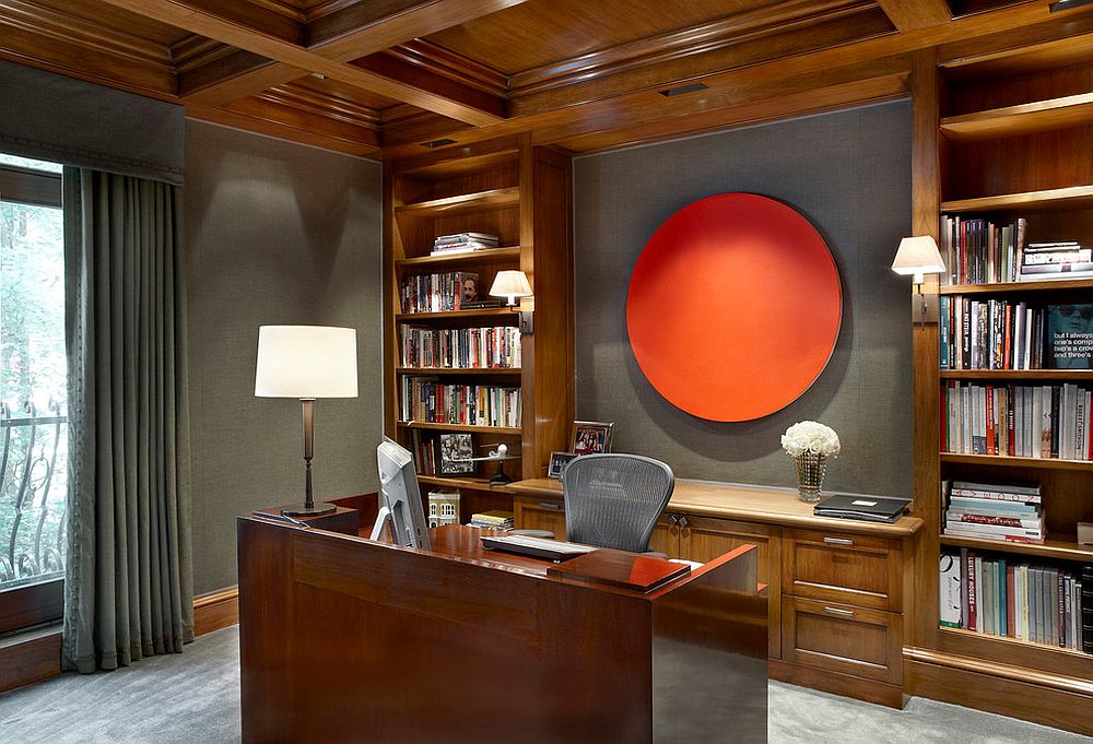 Gray upholstered walls are brought alive with unique orange artwork addition