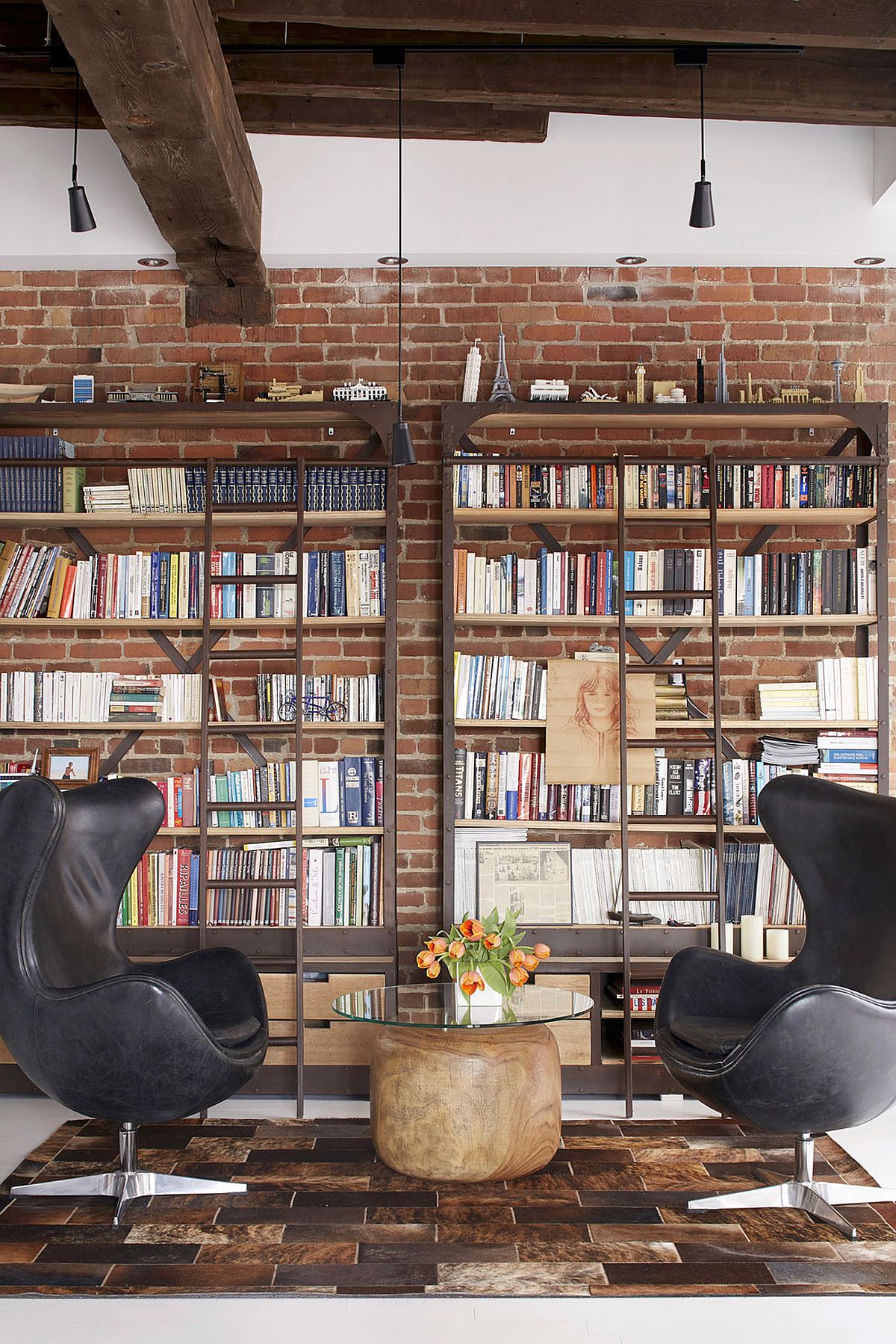 Home library with brick wall backdrop and comfy modern decor