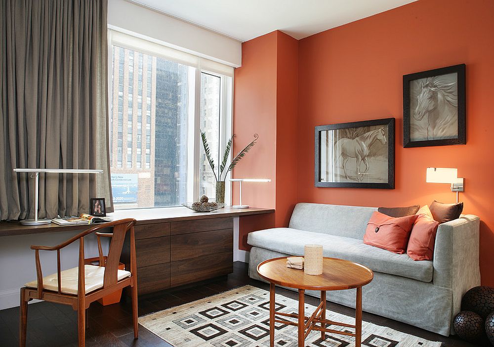 It is drapes and a space savvy couch that bring gray to this home office in orange and white