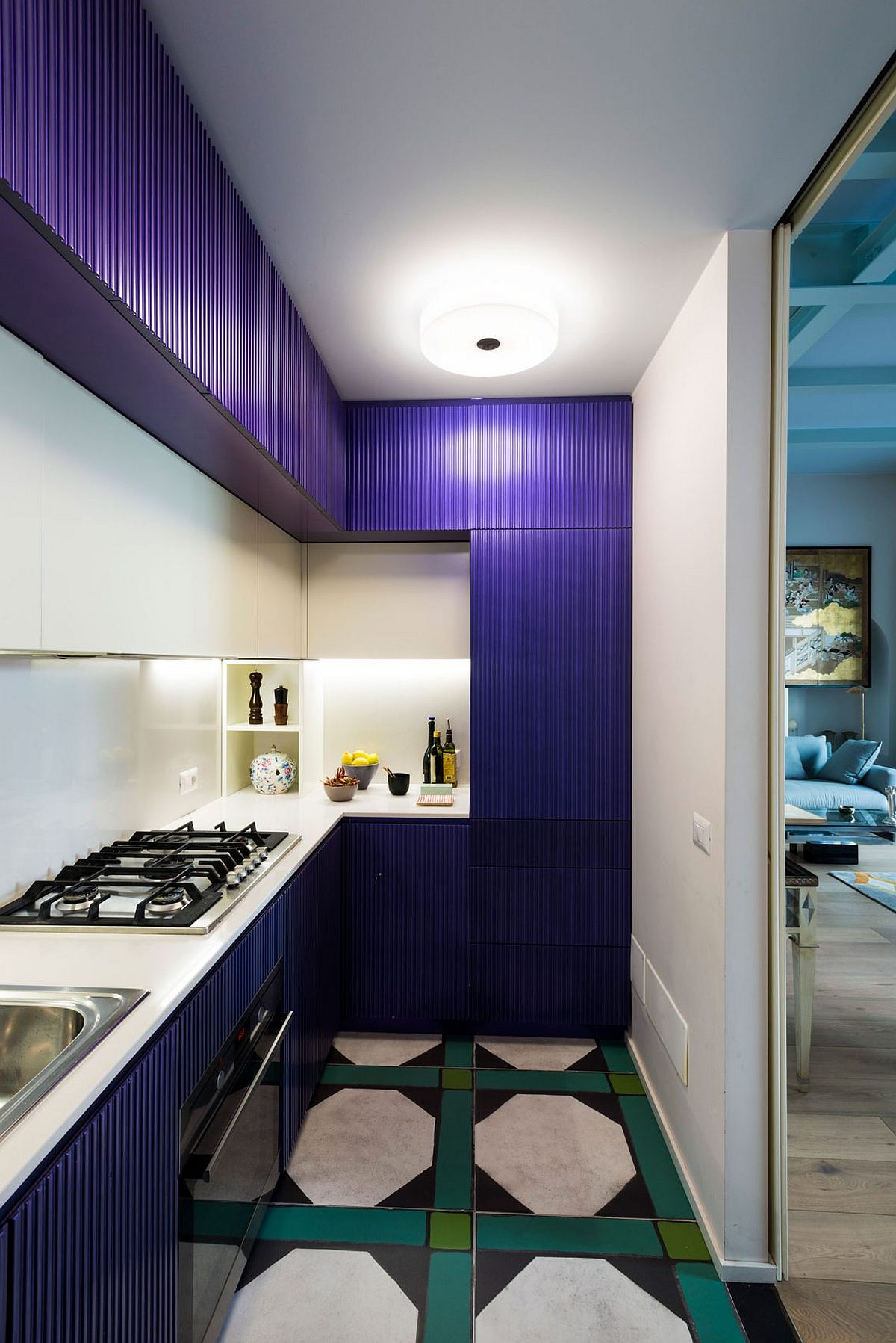 Kitchen cabinets in blue add both color and textural contrast to the small kitchen