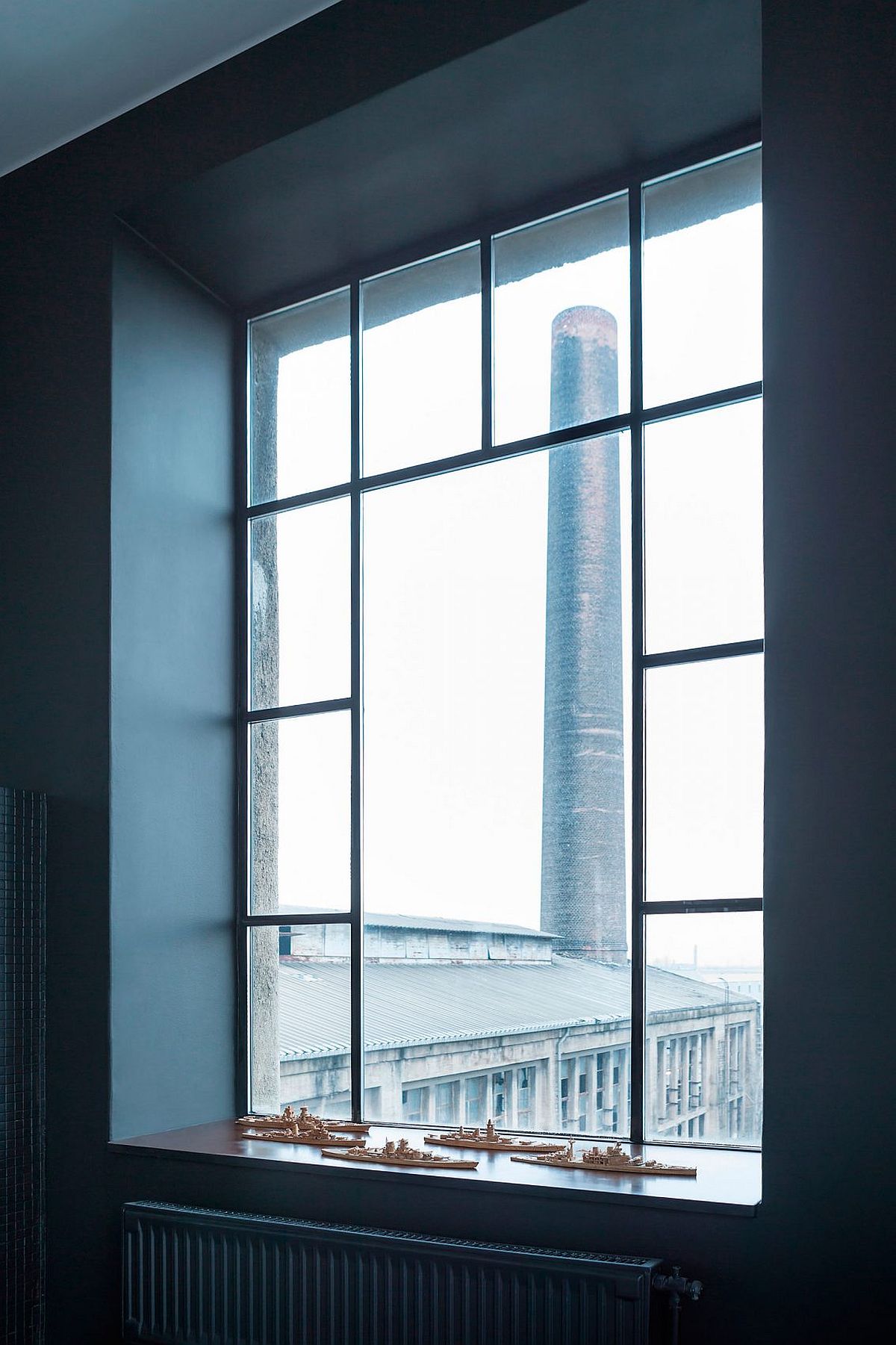 Large industrial style windows bring ample light into the revamped loft