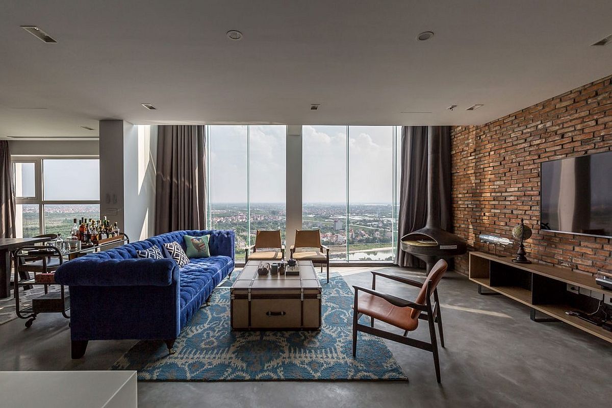 Large windows bring ample light into the living space of modern penthouse