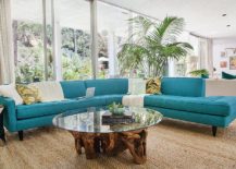 Midcentury family room with striking couch in turquoise and a cool coffee table 217x155 Vibrant Trend: 25 Colorful Sofas to Rejuvenate Your Living Room