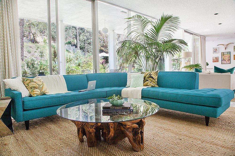 Midcentury family room with striking couch in turquoise and a cool coffee table [Design: Apt2B / HOMEPOLISH]