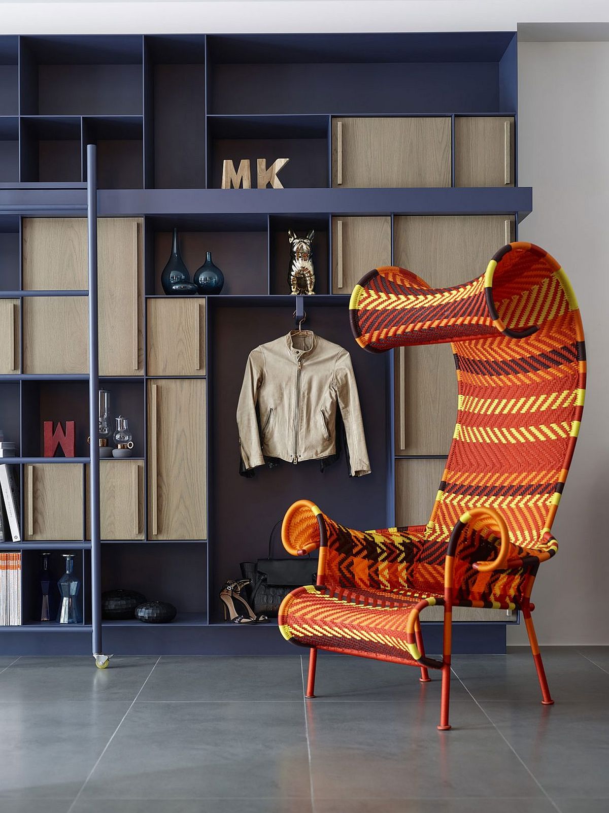 Open bookshelves and bright chair give the living room of Taipei home a distinct charm