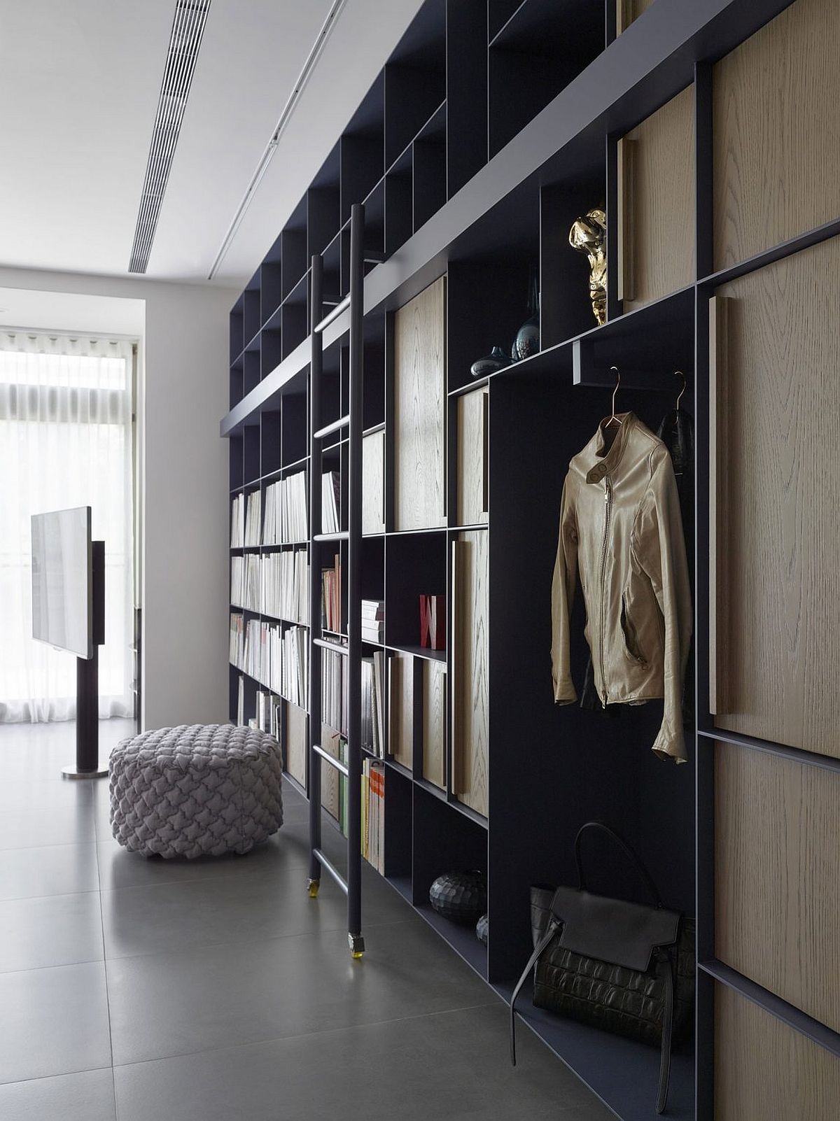 Open living room bookshelf and cabinets that maximize storage space