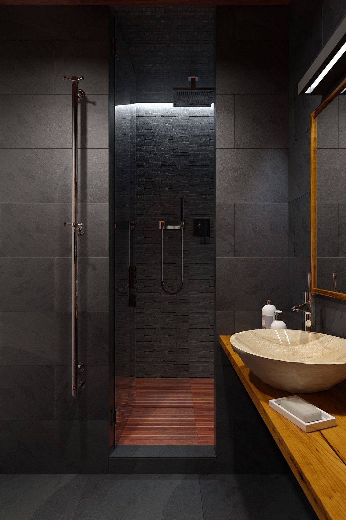 Shower area of the small bathroom inside the stylish bachlor loft clad in slate and teak