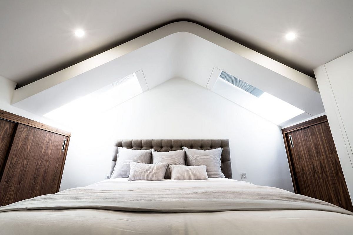 Skylights bring ample natural light into the mezzanine level bedroom