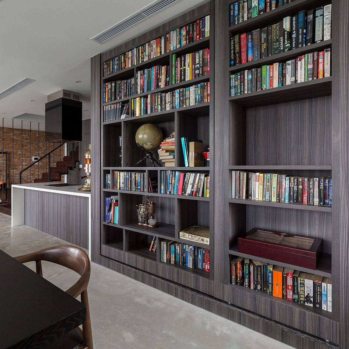 Twin bookshelves that conceal a hidden passageway to the study and guest room