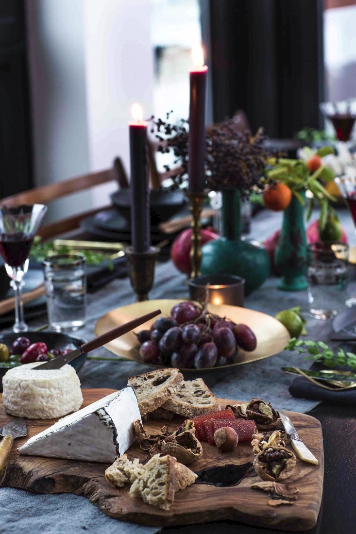 Wooden serving board on a grey table runner via Eyeswoon