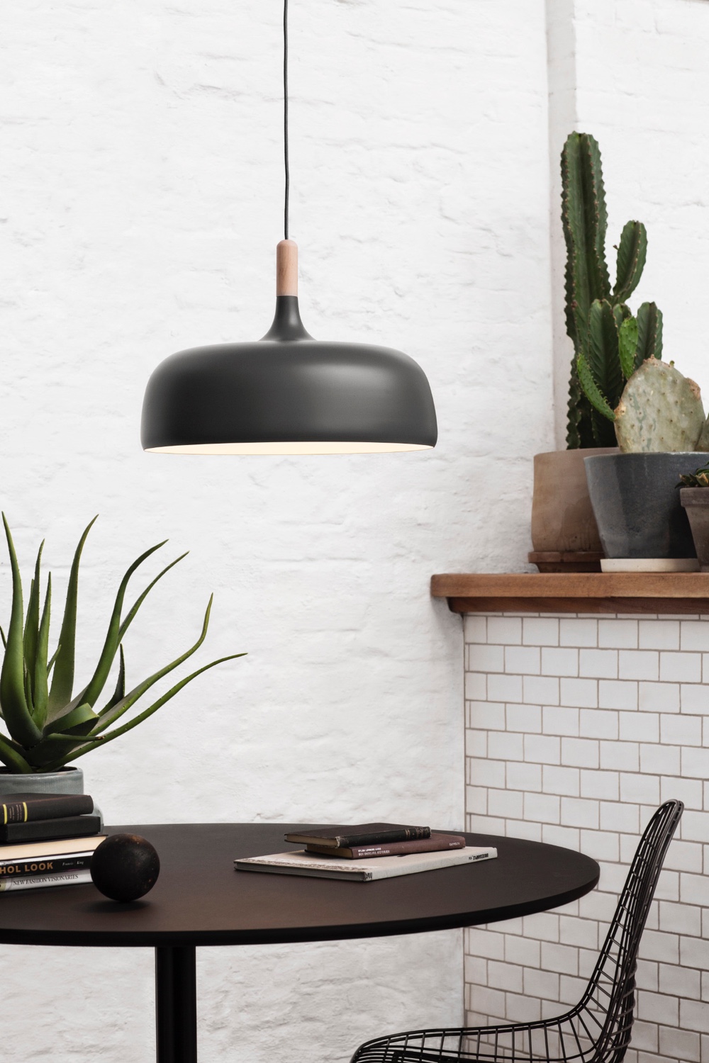 Designed by Atle Tveit, Acorn (in grey) is a contemporary pendant whose shape is inspired by Norwegian autumn forests and the oak acorn.