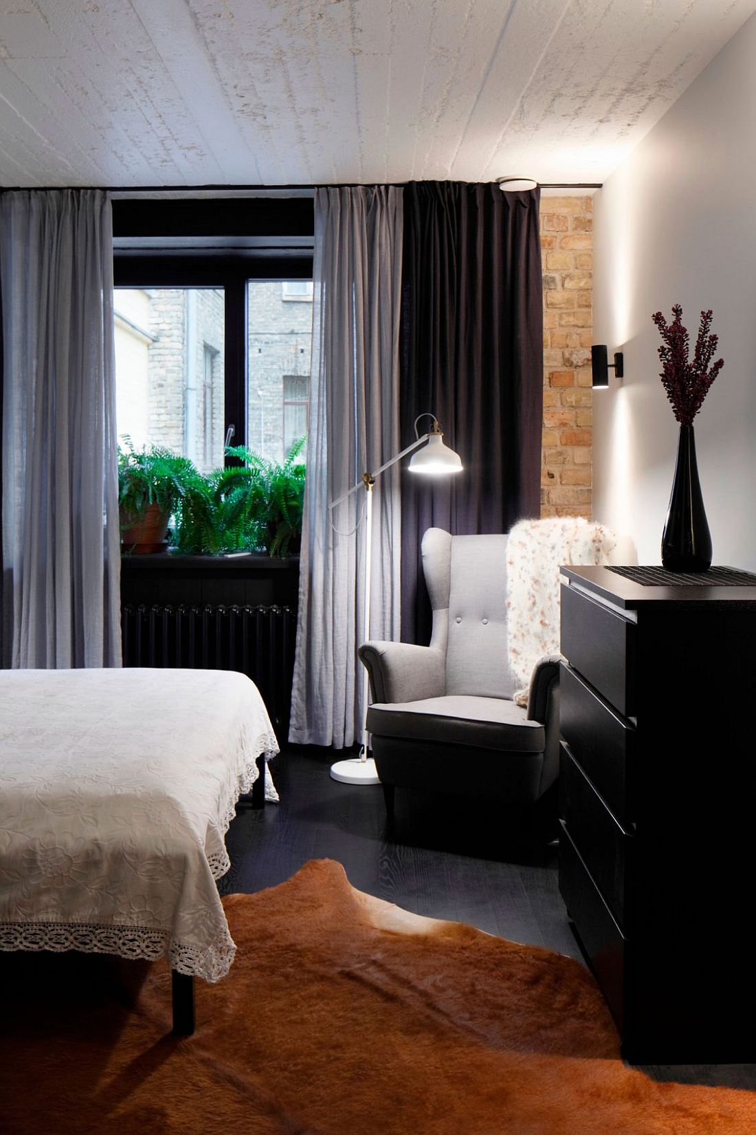 Cozy reading corner in the bedroom with floor lamp